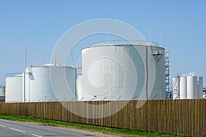 White cylindrical storage tanks for petroleum products