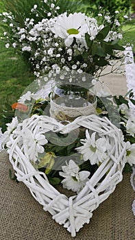 White daisy bouquet in glass jar and wattle white heart in green