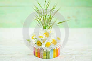 White daisy and pink flower in vase  and grass