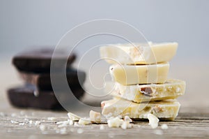 White and dark chocolate on a wooden table