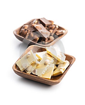 White and dark nutty chocolate with hazelnuts in bowl