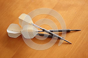 White darts on wooden board of cherry tree