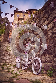 White decor bike near the stone wall