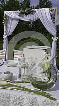 White decoration of the wedding table and arch