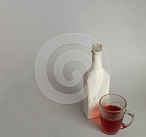 White decorative christmas bottle with rose wine in cup