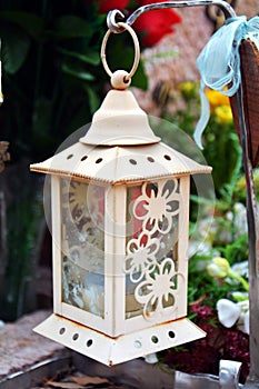 White decorative lamp and lighted candle, as decoration in cemetery photo