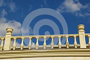 White decorative stone balustrade against the blue sky.