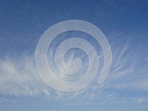 White delicate clouds in blue sky of autumn