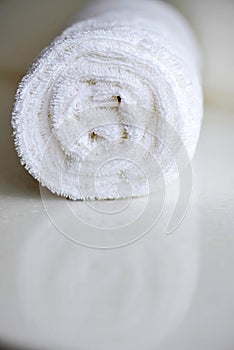 White delicate soft background of fur plush smooth fabric. Clean white towel rolled blanket textile