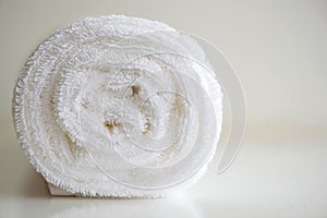 White delicate soft background of plush smooth fabric. Clean white terry towel rolled blanket textile horizontal photo