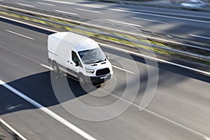 White deliver van on highway