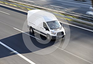 White deliver van on highway