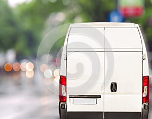 White delivery Van driving fast on city blurr bokeh street