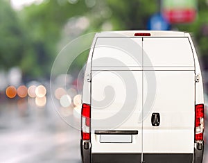 White delivery Van driving fast on city blurr bokeh street photo