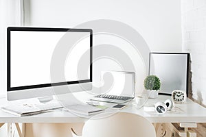 White designer desktop with computer and laptop