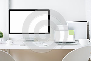 White designer desktop with computer and laptop
