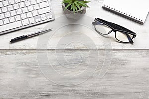 White desk office with laptop, smartphone and other work supplies with cup of coffee. Top view with copy space for input