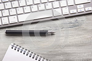 White desk office with laptop, smartphone and other work supplies with cup of coffee. Top view with copy space for input