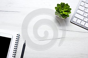 White desk office with laptop, smartphone and other work supplies with cup of coffee. Top view with copy space for input