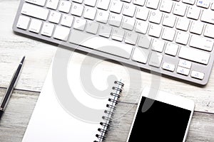 White desk office with laptop, smartphone and other work supplies with cup of coffee. Top view with copy space for input