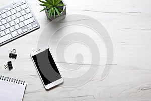 White desk office with laptop, smartphone and other work supplies with cup of coffee. Top view with copy space for input