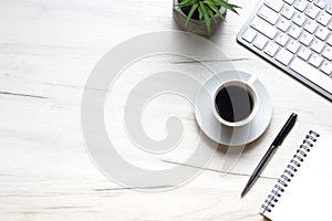 White desk office with laptop, smartphone and other work supplies with cup of coffee. Top view with copy space for input