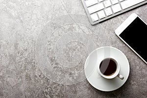 White desk office with laptop, smartphone and other work supplies with cup of coffee. Top view with copy space for input