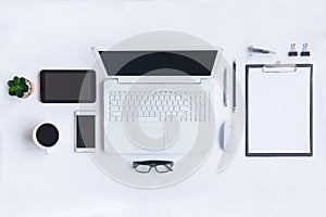 White desk office with laptop, smartphone and other work supplies with cup of coffee. Top view with copy space for input the text