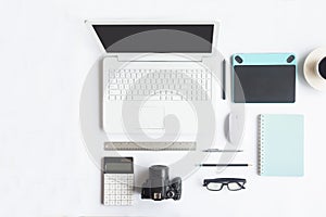 White desk office with laptop, smartphone and other work supplies with cup of coffee. Top view with copy space for input the text