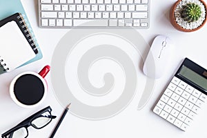 White desk office with laptop, smartphone and other work supplies with cup of coffee. Top view with copy space for input the text