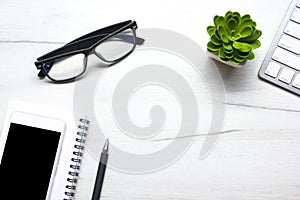 White desk office with laptop, smartphone and other work supplies with cup of coffee. Top view with copy space for input the text