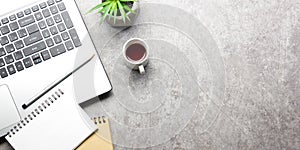 White desk office with laptop, smartphone and other work supplies with cup of coffee. Top view with copy space for input the text