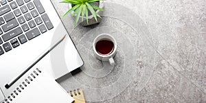 White desk office with laptop, smartphone and other work supplies with cup of coffee. Top view with copy space for input the text