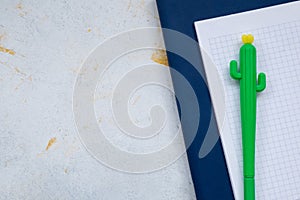 White desktop, green notebook lies on the table, pensil, with copy space, for advertisement