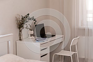 White desktop with laptop for remote work or study. Office computer workplace in home interior