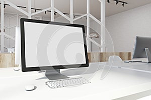 White desktop screen on an office table side
