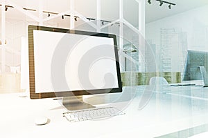 White desktop screen on an office table side toned