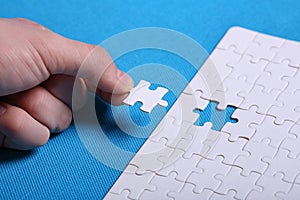 White details of a puzzle on a blue background. A puzzle is a pu