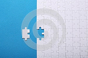 White details of a puzzle on a blue background. A puzzle is a pu