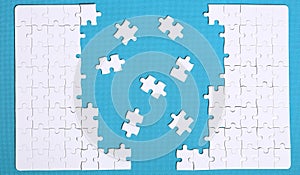 White details of a puzzle on green background. A puzzle is a puz