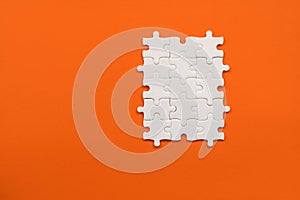 White details of puzzle on orange background