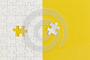 White details of puzzle on yellow background. Business strategy, teamwork