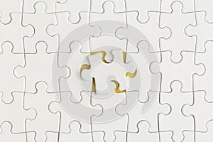 White details of puzzle on yellow background. Business strategy, teamwork. Top view with copy space. Flat lay