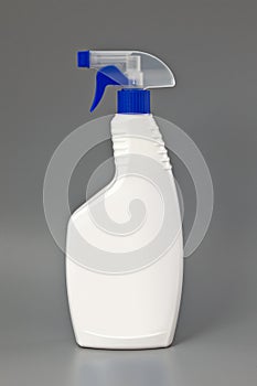 White detergent plastic spray bottle Isolated on gray