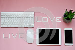 White devices on pink background with love live sign. mock up