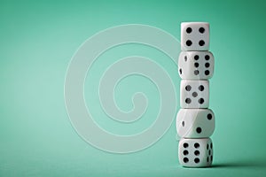 White dice on green background. Gambling devices. Copy space for text. Game of chance concept.