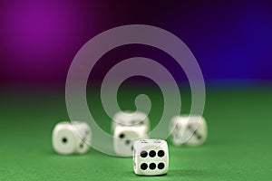 White dice on green felt table close up