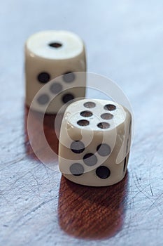 White dice on wooden background. Concept of luck, chance and lei