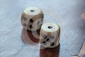 White dice on wooden background. Concept of luck, chance and lei