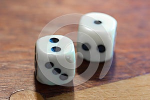 White dice on wooden background. Concept of luck, chance and lei